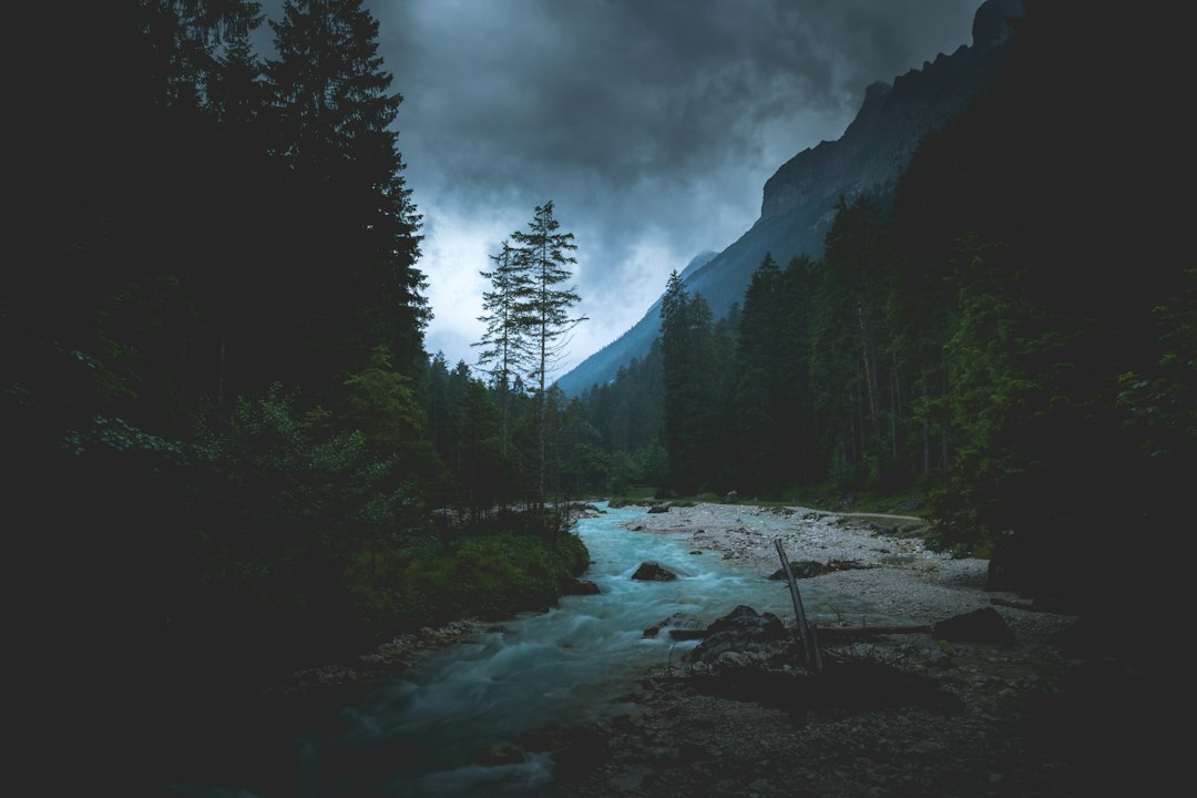 Dark atmospheric mountain landscape used as fictional game key art