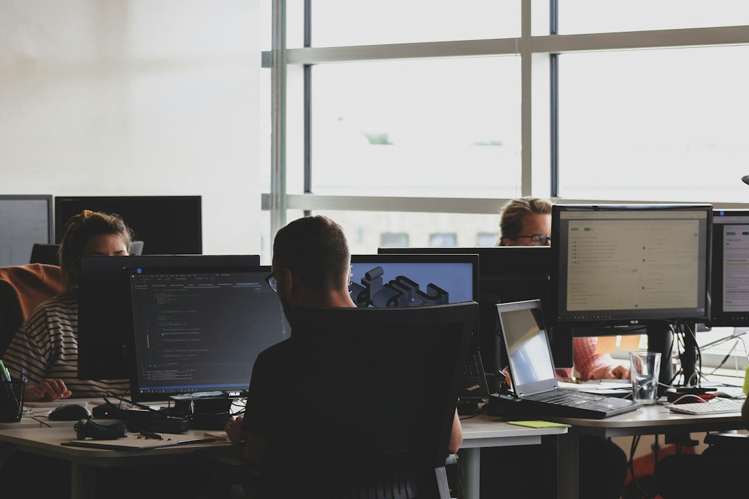 Small game development team working at computers